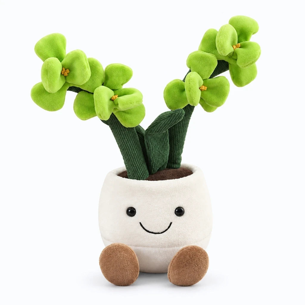 Peluche kawaii en forme de pot de fleurs de 35 cm, ronde et rembourrée, posée sur un lit