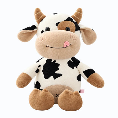 Peluche vache aux taches noires et blanches, vêtue d'un pull tricoté coloré